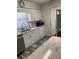 Updated kitchen with stainless steel appliances and white cabinets at 301 Paradise Ln, Edgewater, FL 32132