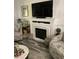 Cozy living room with fireplace and wall-mounted television above mantel at 301 Paradise Ln, Edgewater, FL 32132