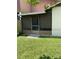 Enclosed patio with seating area and access to backyard at 301 Paradise Ln, Edgewater, FL 32132