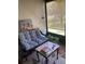 Relaxing screened porch area featuring comfortable wicker seating and natural light at 301 Paradise Ln, Edgewater, FL 32132