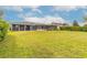 Lush backyard with large lawn area, screened porch, and mature landscaping at 317 Oak Hill Dr, Altamonte Springs, FL 32701