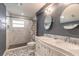 Well-appointed bathroom with double sinks, marble countertops and a tiled walk-in shower at 317 Oak Hill Dr, Altamonte Springs, FL 32701
