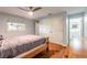 Cozy bedroom featuring hardwood floors, a ceiling fan, closet space, and an ensuite bathroom at 317 Oak Hill Dr, Altamonte Springs, FL 32701