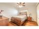 Light-filled bedroom with hardwood floors, ceiling fan, and a large window with privacy shade at 317 Oak Hill Dr, Altamonte Springs, FL 32701