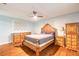 Bright bedroom with hardwood floors, ceiling fan, and matching wooden dresser and nightstand set at 317 Oak Hill Dr, Altamonte Springs, FL 32701