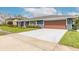 Angle view of the driveway and the side of the single-story home at 317 Oak Hill Dr, Altamonte Springs, FL 32701