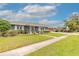 Well-maintained front yard with lush green grass and mature trees at 317 Oak Hill Dr, Altamonte Springs, FL 32701