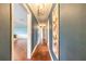 Long hallway with hardwood floors, neutral walls, decorative lighting and modern art at 317 Oak Hill Dr, Altamonte Springs, FL 32701
