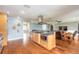 Open kitchen with stainless steel appliances, breakfast bar, and hardwood floors flows to living area at 317 Oak Hill Dr, Altamonte Springs, FL 32701