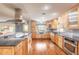 Spacious eat-in kitchen features stainless appliances, granite counters, hardwood floors, and window seat at 317 Oak Hill Dr, Altamonte Springs, FL 32701