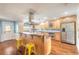 Bright kitchen features hardwood floors, stainless steel appliances, breakfast bar, and blue accent wall at 317 Oak Hill Dr, Altamonte Springs, FL 32701