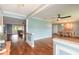 Open concept living room and dining area features hardwood floors and blue accent walls at 317 Oak Hill Dr, Altamonte Springs, FL 32701
