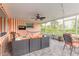 Bright screened patio featuring stylish furniture, ceiling fan and string lights at 317 Oak Hill Dr, Altamonte Springs, FL 32701