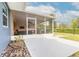Backyard view of screened porch with comfortable seating and an open yard at 317 Oak Hill Dr, Altamonte Springs, FL 32701