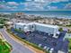 Aerial view of a condo building across the street from the beach, with a parking lot, and easy access to the ocean at 3700 S Atlantic Ave # 111, New Smyrna Beach, FL 32169