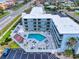 Aerial view of building with pool and parking at 3700 S Atlantic Ave # 111, New Smyrna Beach, FL 32169