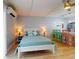 Cozy bedroom featuring a double bed, ceiling fan, and adjacent eating area at 3700 S Atlantic Ave # 111, New Smyrna Beach, FL 32169