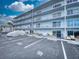 Exterior shot of building with carports and parking at 3700 S Atlantic Ave # 111, New Smyrna Beach, FL 32169