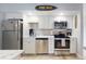 Well-equipped kitchen featuring white cabinetry, stainless steel appliances, and sleek countertops for easy meal prep at 3700 S Atlantic Ave # 111, New Smyrna Beach, FL 32169