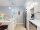 Efficient kitchen with white cabinets, stainless steel appliances, and a spacious countertop, creating an inviting cooking space at 3700 S Atlantic Ave # 111, New Smyrna Beach, FL 32169