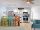 Cozy living space combining a fully equipped kitchen, comfortable seating, and relaxed decor with ample natural light at 3700 S Atlantic Ave # 111, New Smyrna Beach, FL 32169