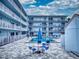 Exterior shot of building with pool, tables, chairs, and building at 3700 S Atlantic Ave # 111, New Smyrna Beach, FL 32169