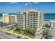 Aerial view of oceanfront condo building with blue skies at 3703 S Atlantic Ave # 507, Daytona Beach Shores, FL 32118