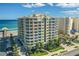 Aerial view of oceanfront condo building with blue skies at 3703 S Atlantic Ave # 507, Daytona Beach Shores, FL 32118