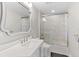 Modern bathroom features a sleek vanity, stylish mirror, and a glass-enclosed shower-tub combination with tiled walls at 3703 S Atlantic Ave # 507, Daytona Beach Shores, FL 32118