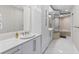 Bright bathroom featuring double vanities, modern fixtures, and a glass-enclosed shower and tub at 3703 S Atlantic Ave # 507, Daytona Beach Shores, FL 32118