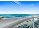 Beautiful beach view from a balcony, overlooking the ocean, sand, and pier in the distance on a lovely day at 3703 S Atlantic Ave # 507, Daytona Beach Shores, FL 32118