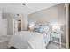 Cozy bedroom featuring coastal-themed decor and furnishings with easy access to an ensuite bathroom and a door to a living space at 3703 S Atlantic Ave # 507, Daytona Beach Shores, FL 32118