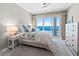 Bright bedroom featuring coastal-themed decor, a ceiling fan, and a sliding glass door with ocean views at 3703 S Atlantic Ave # 507, Daytona Beach Shores, FL 32118