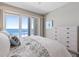 A bright bedroom featuring coastal-themed decor, and a sliding glass door to the balcony, with ocean views at 3703 S Atlantic Ave # 507, Daytona Beach Shores, FL 32118