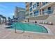 Resort-style pool with lounge chairs and palm trees overlooking the ocean at 3703 S Atlantic Ave # 507, Daytona Beach Shores, FL 32118
