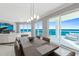 Elegant dining room with modern lighting fixtures and open access to the outdoor terrace at 3703 S Atlantic Ave # 507, Daytona Beach Shores, FL 32118