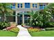 Landscaped entrance to Ocean Villas featuring colorful flowers, greenery, and a water feature at 3703 S Atlantic Ave # 507, Daytona Beach Shores, FL 32118