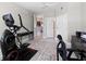 Bright room with modern exercise equipment with easy access to the kitchen, bathroom, and another living space at 3703 S Atlantic Ave # 507, Daytona Beach Shores, FL 32118