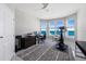 Bright home gym with modern exercise equipment, a desk, and a stunning ocean view from multiple windows at 3703 S Atlantic Ave # 507, Daytona Beach Shores, FL 32118