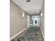 Hallway features modern lighting fixtures, neutral color walls, and patterned carpet at 3703 S Atlantic Ave # 507, Daytona Beach Shores, FL 32118