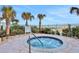 The beautiful community hot tub features a tile surround and lush landscaping at 3703 S Atlantic Ave # 507, Daytona Beach Shores, FL 32118