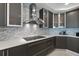 Sleek, modern kitchen boasts custom cabinets, quartz countertops, and a stylish backsplash, offering elegance at 3703 S Atlantic Ave # 507, Daytona Beach Shores, FL 32118