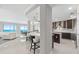 Open-concept kitchen offers an eat-in island, modern appliances, and ocean views, perfect for gatherings at 3703 S Atlantic Ave # 507, Daytona Beach Shores, FL 32118