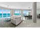 Living room with ocean view, ceiling fan, and tile flooring at 3703 S Atlantic Ave # 507, Daytona Beach Shores, FL 32118