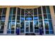 The grand entrance to the building boasts tall glass windows and elegant potted plants at 3703 S Atlantic Ave # 507, Daytona Beach Shores, FL 32118