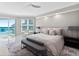 Bright, airy bedroom with ocean view, ceiling fan, and stylish decor at 3703 S Atlantic Ave # 507, Daytona Beach Shores, FL 32118