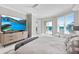 Serene bedroom featuring a TV, ocean view, and inviting lounge chairs at 3703 S Atlantic Ave # 507, Daytona Beach Shores, FL 32118