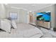 Relaxing bedroom with a large TV, soft lighting, and scenic artwork at 3703 S Atlantic Ave # 507, Daytona Beach Shores, FL 32118