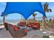 Comfortable outdoor patio seating area with a large sunshade overlooking the ocean at 3703 S Atlantic Ave # 507, Daytona Beach Shores, FL 32118