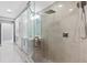 Modern shower with glass enclosure, rainfall shower head, and elegant fixtures at 3703 S Atlantic Ave # 507, Daytona Beach Shores, FL 32118